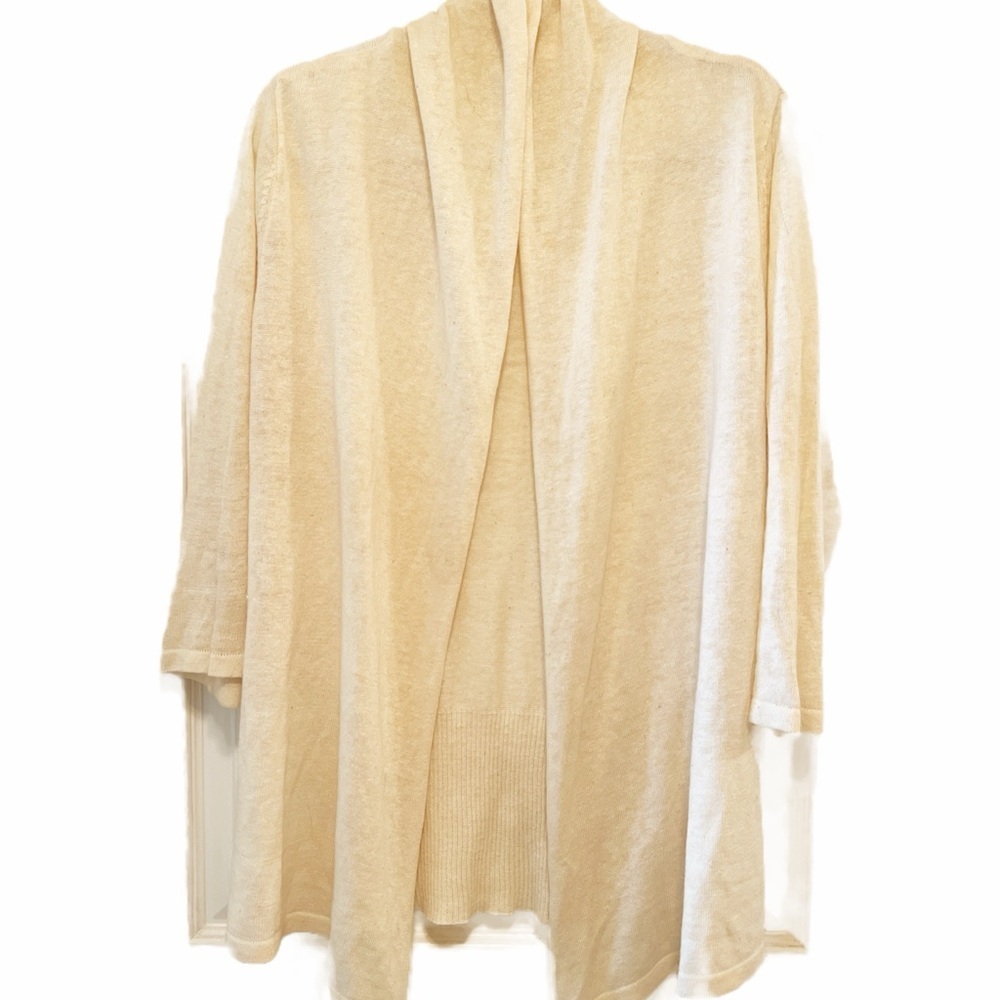 Cream Knit shrug with asymmetrical Open Front design.
